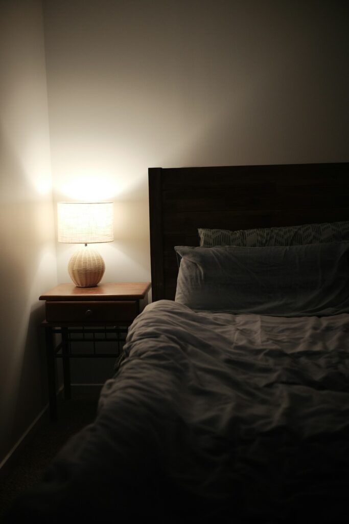 a bedroom with a bed and a night stand