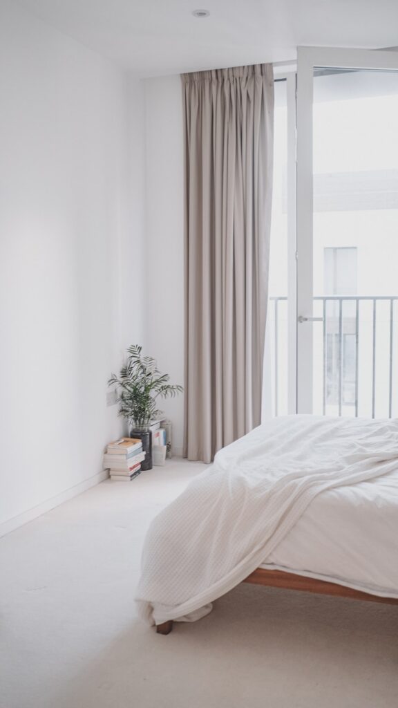 a bedroom with a large bed and a balcony