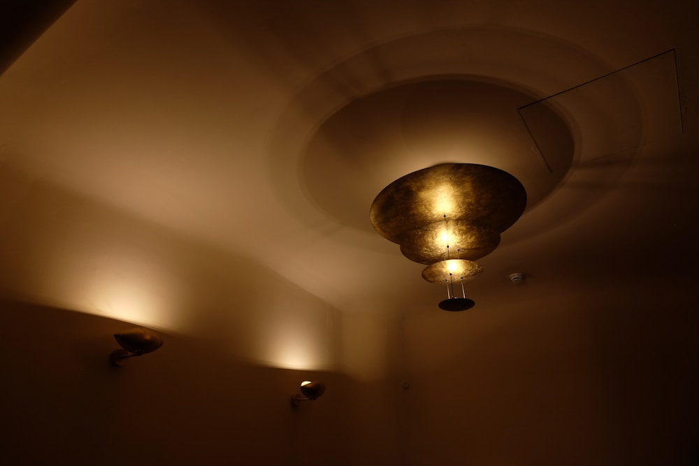 a dimly lit room with three lights on the ceiling